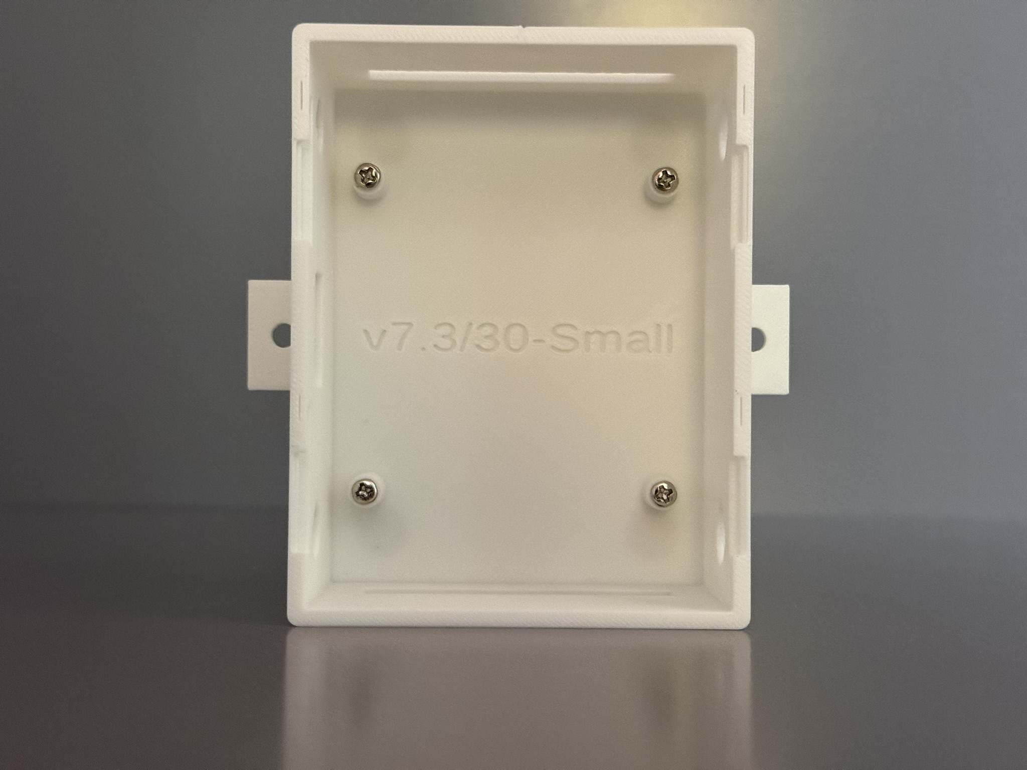 Scout family enclosure empty interior showing installed screws and standoffs